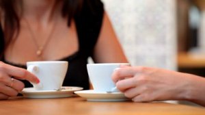 stock-footage-two-girls-having-coffee-in-cafe